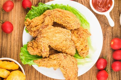 Premium Photo Fried Chicken Wings On Wooden Table