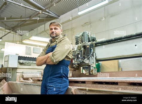 Mature Factory Worker Posing With Cutting Machine Stock Photo Alamy
