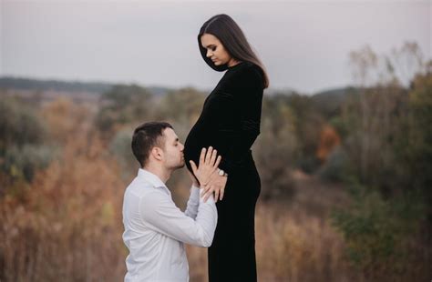 Premium Photo A Pregnant Woman Is Standing On A Hill And The Man Is