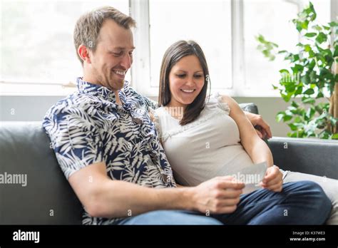 Happy Couple Are Holding Ultrasound Scan Of Their Baby Stock Photo Alamy