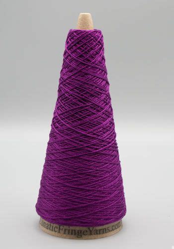 Purple Yarn Is Spooled On Top Of A Wooden Stand