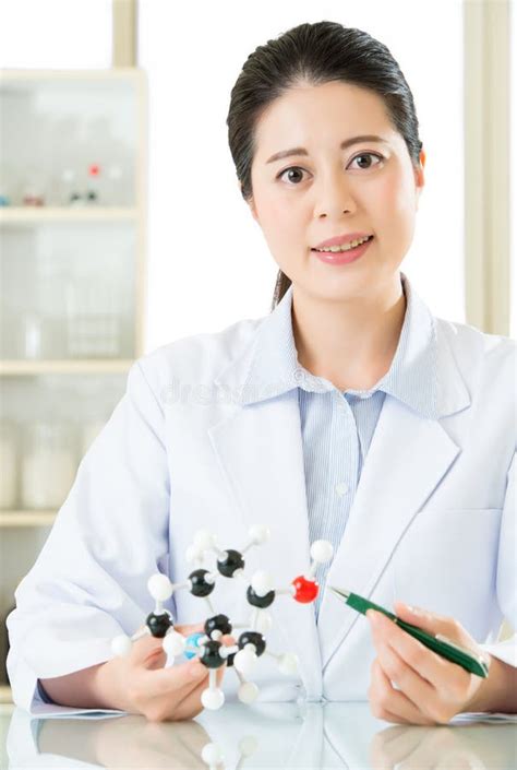 Asian Female Scientist Teacher Point At Molecular Model Explain Stock