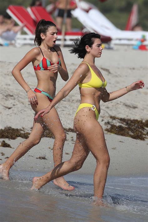 Dua Lipa Wears A Yellow Bikini As She Takes A Dip In The Ocean With Her