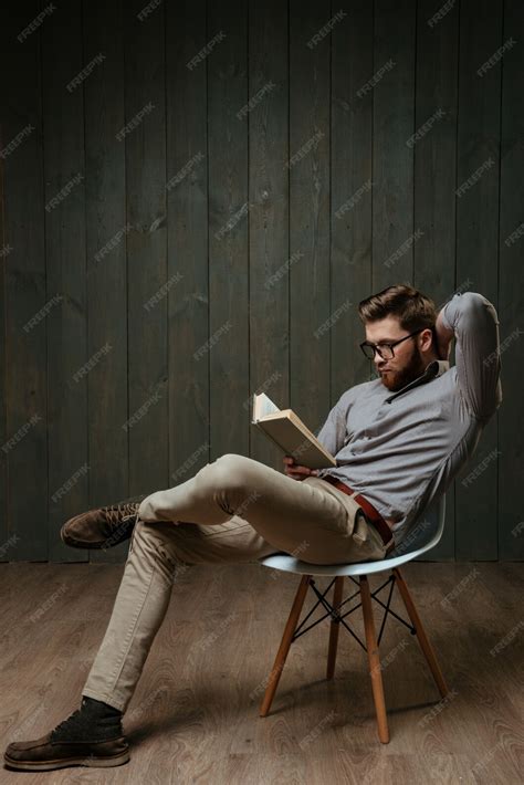 Premium Photo Full Length Portrait Of A Pensive Bearded Man Reading