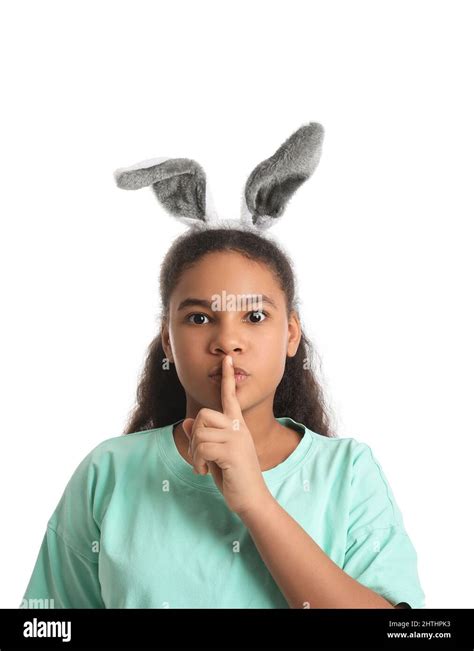 Cute African American Girl With Bunny Ears Showing Silence Gesture On