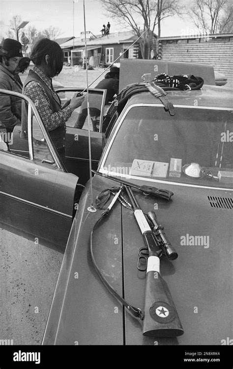 An Unidentified Native American Member Of Aim Looks Over His Weapons