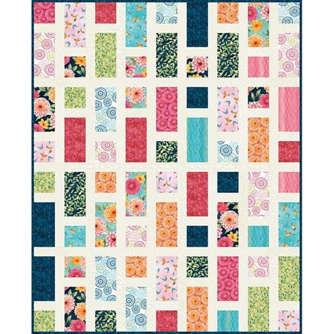 A Quilt Made With Colorful Squares And Flowers
