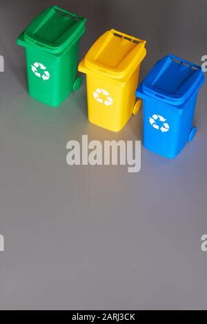 Three Color Coded Recycle Bins Isometric Projection On Layered Paper