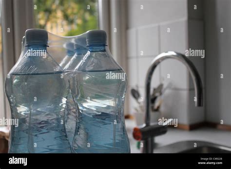 Bottled water and water tap in backround hi-res stock photography and ... 