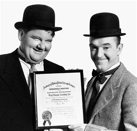 Stan Laurel And Oliver Hardy Pose With The Certificate The Music Box Won At The 1932 Academy