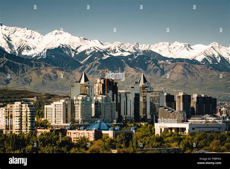 City landscape on a background of snow-capped Tian Shan mountains in ...