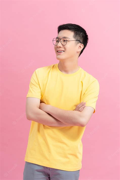 Premium Photo Asian Young Handsome Man In Yellow T Shirt Smiling On