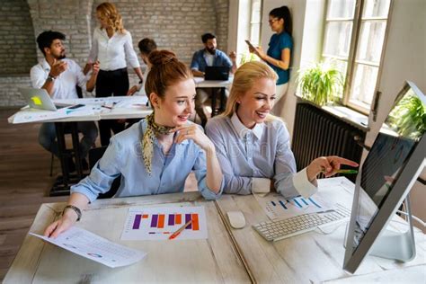Portrait Of Business Women Working Together In Corporate Office
