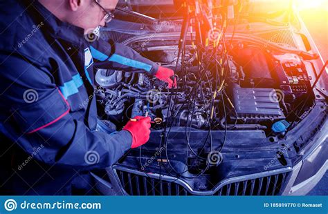 Auto Mechanic Uses A Voltmeter To Check The Voltage Level Stock Photo