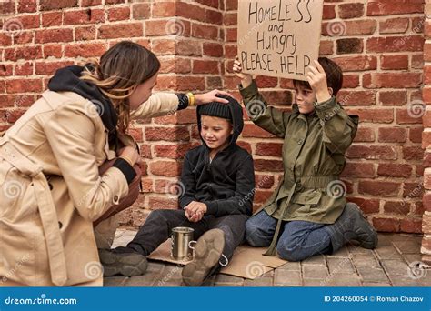 Stranger Woman In Street Helping Homeless Children Stock Photo Image