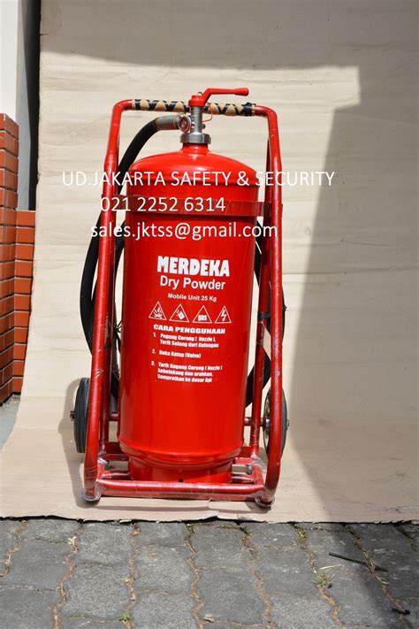 A Red Fire Extinguisher Sitting In Front Of A Building