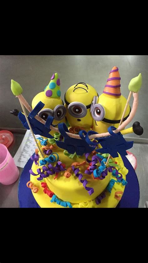 A Birthday Cake Decorated With Yellow Frosting And Decorations