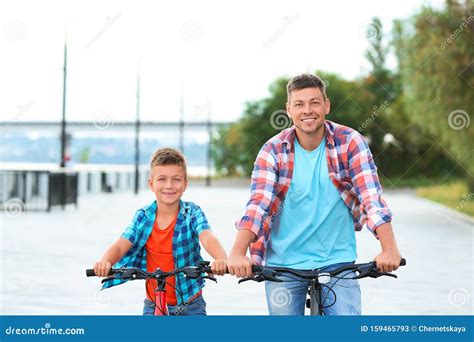 Dad And Son Riding Bicycles Together Stock Image Image Of Action