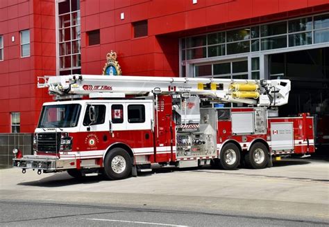 A Red Fire Truck Parked In Front Of A Building