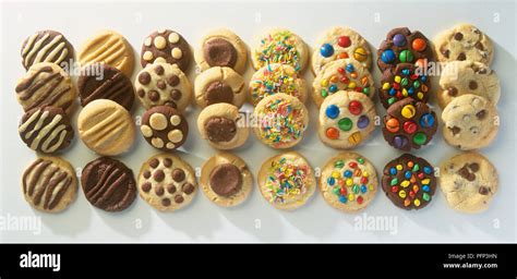 Rows Of Round Biscuits Decorated With A Selection Of Sweets Stock Photo