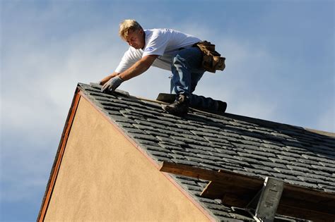 A Man Working On The Roof Of A House