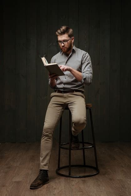 Premium Photo Concentrated Handsome Young Bearded Man In Eyeglasses