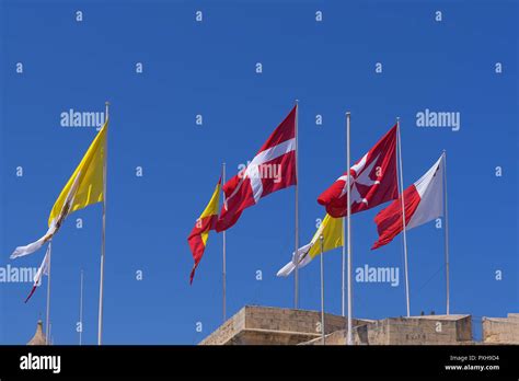 Many Different Flags Over The City Of Birgu Malta Against Blue Clear