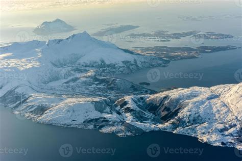 An aerial view of the snow covered mountains of the fjords of Norway in the winter. 16102955 ...