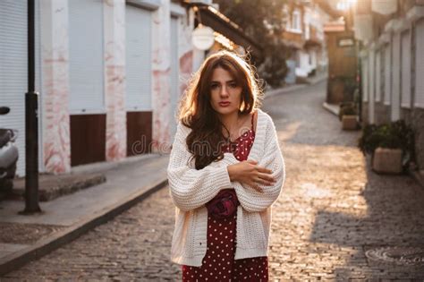Attractive Sad Brunette Girl Is Warming Up On Street Wrapped In A Sweater Stock Photo Image Of
