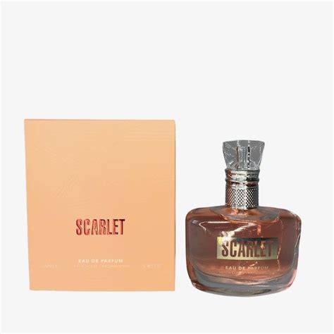 A Bottle Of Perfume Sitting Next To A Box