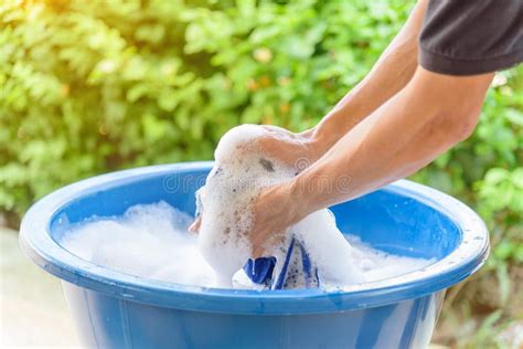 Hand Washing Clothes in Blue Basin Stock Photo - Image of bubble ...