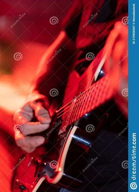 Vertical Image Of A Man Playing The Electric Guitar Shallow Depth Of