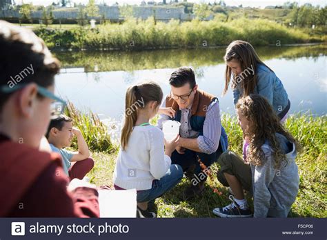 Science Teacher And Students Testing Water Field Trip Stock Photo Alamy