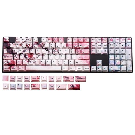 A Computer Keyboard Covered In Pink And White Keys With Pictures On The