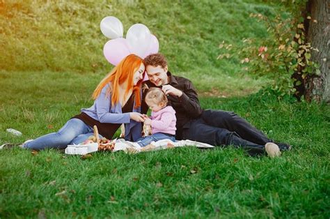 Premium Photo A Young Redheaded Mother Sitting In The Park With Her