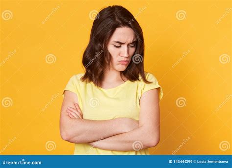 Portrait Of Upset Unsatisfied Caucasian Woman Standing With Arms Folded