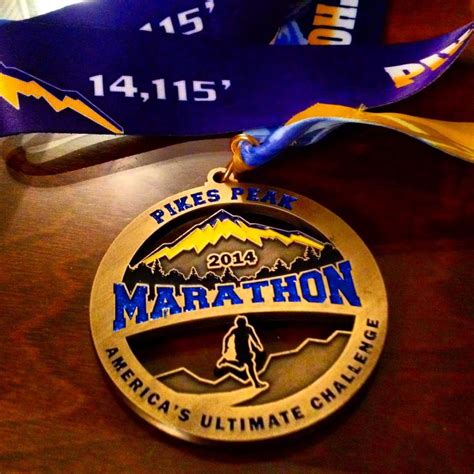 Pikes Peak Marathon Medal on Wooden Table