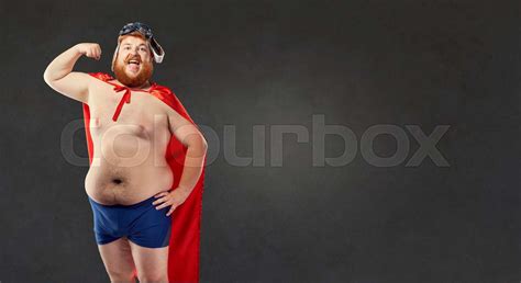 Big Fat Naked Man In A Superhero Costume Shows The Muscles On Hi