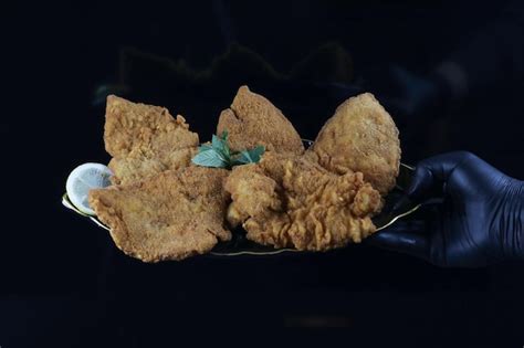 Premium Photo Hand Holding Nicely Fried Chicken Scallopini Plate