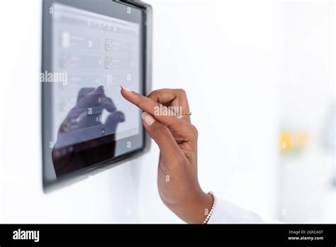 Young African Modern Muslim Woman Using Smart Home Screen Control