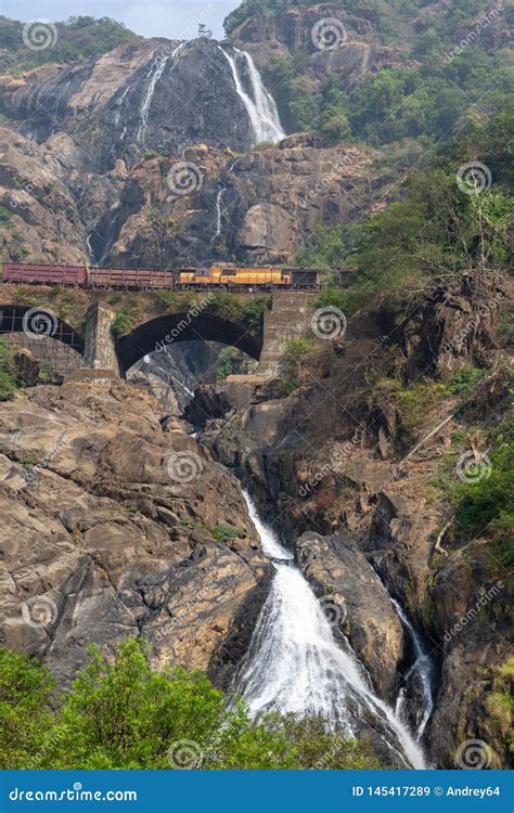 Train on the Railway Bridge on the Background of the Dudhsagar Falls Stock Image - Image of ...