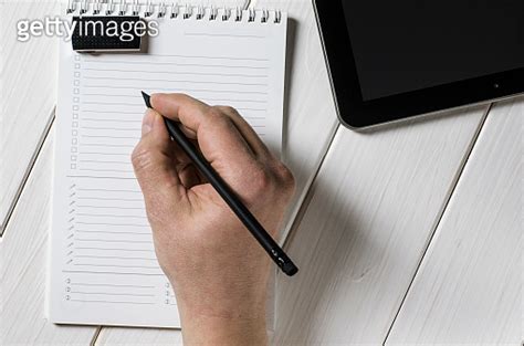 Man Hands Writing Notes To The Notebook On Wooden Table In Home Office