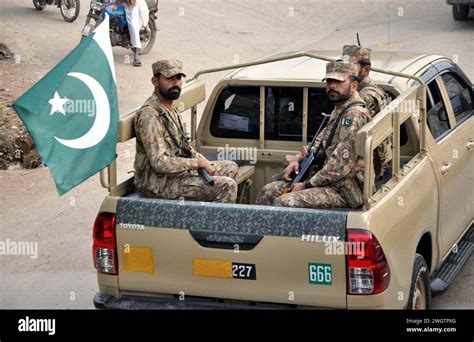 Security Personnel Convoy Patrols In City During Flag March To Maintain