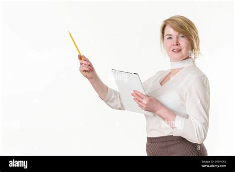Mature Businesswoman Holding Clipboard And Pointing Up Finger With