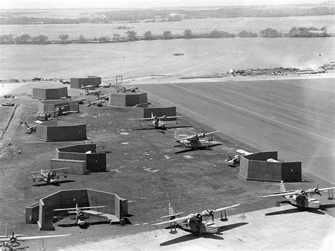 Ford Island, Pearl Harbor, early 1942. Note the newly constructed blast proof revetments built ...