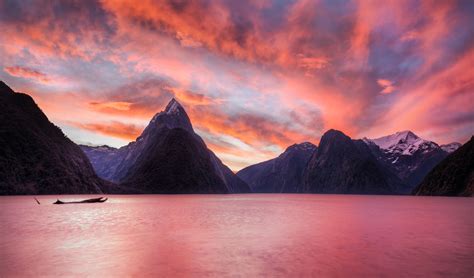 Photo Of Boat On Body Of Water Near Mountains During Dawn Time Hd