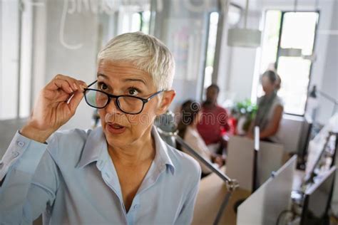 Portrait Of Mature Business Woman Smile While While Analyzing Work Processes Stock Photo Image