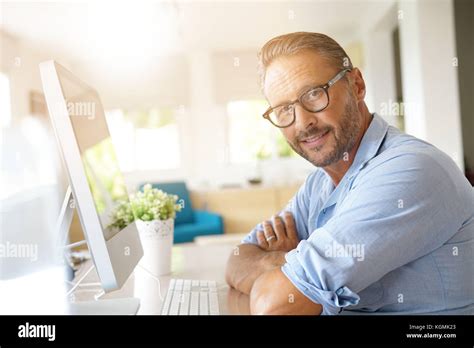 Mature Man Working From Home On Desktop Computer Stock Photo Alamy