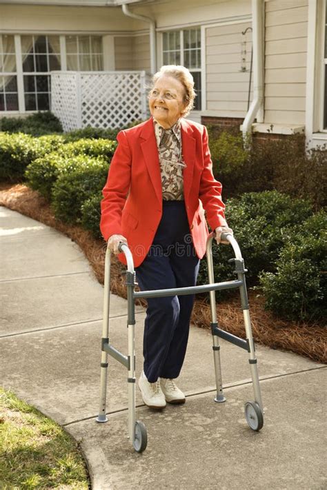 Elderly Woman Using Walker stock photo. Image of female - 12624514