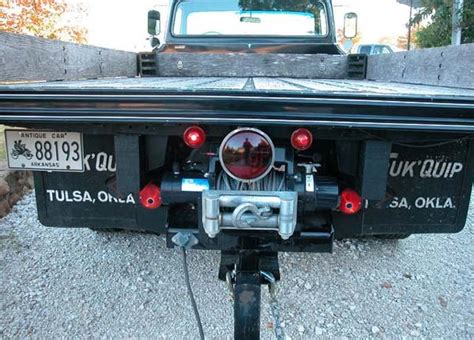 the back end of a pickup truck with its lights on